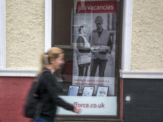 woman walking past job centre