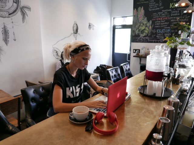 Young woman sitting at a laptop