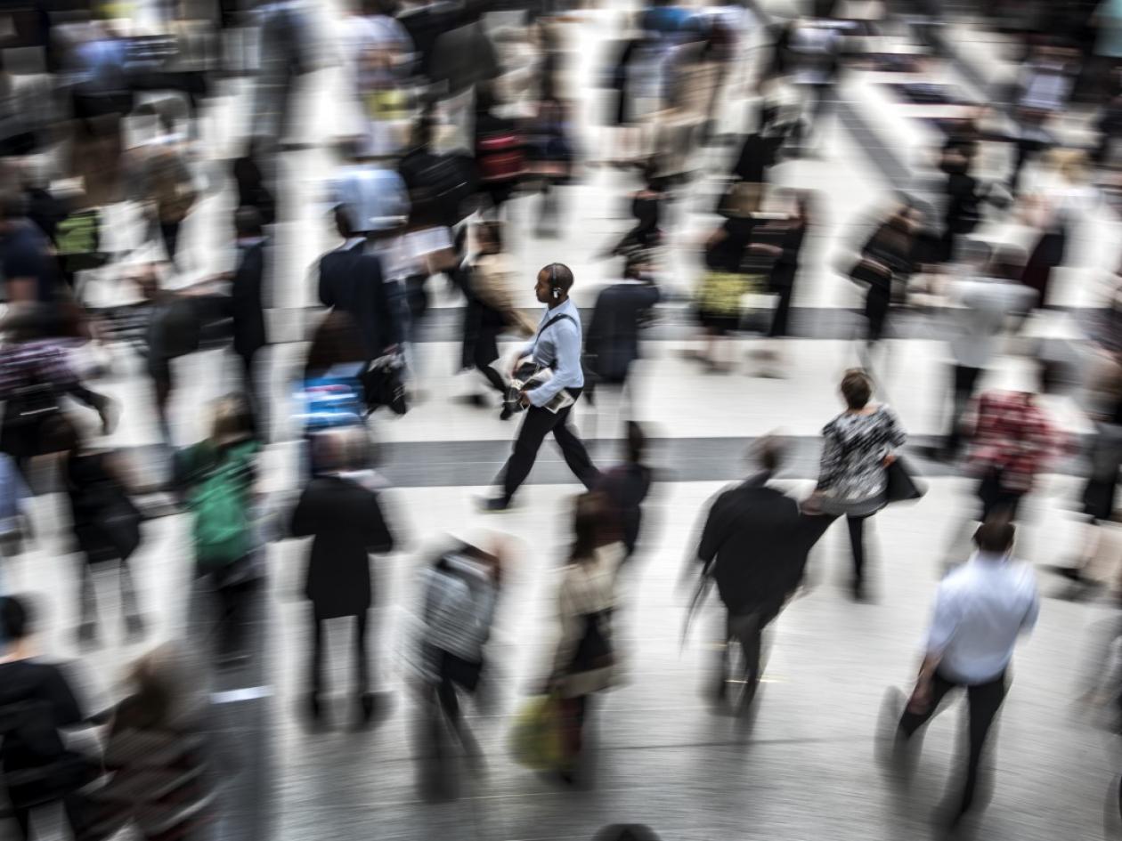 person walking across station concourse