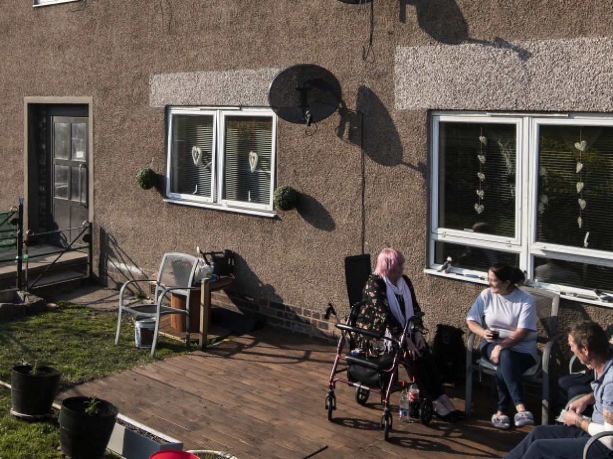 people sitting outside in a back yard