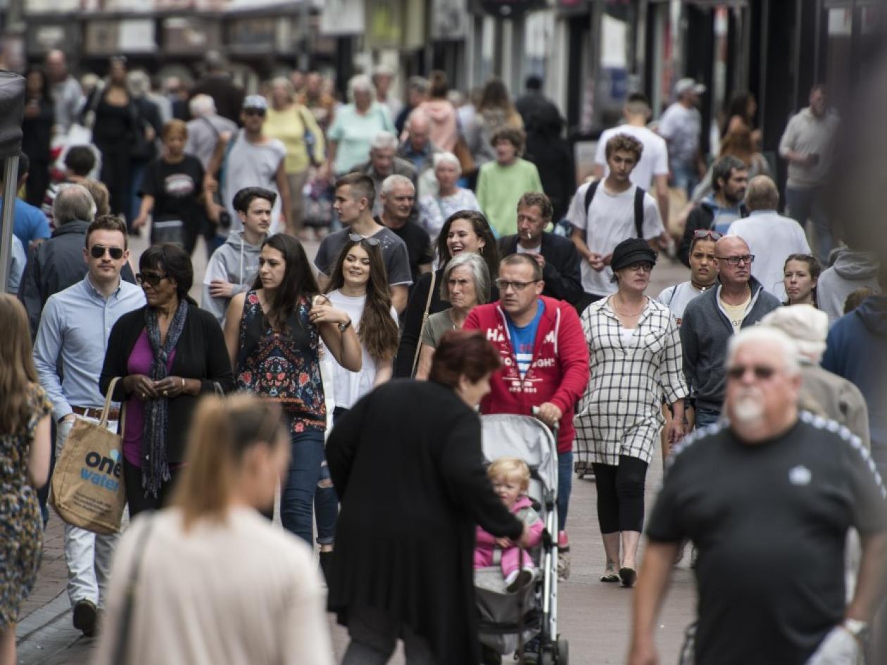a crowd of people in a shopping area
