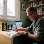A middle aged man signs some paperwork