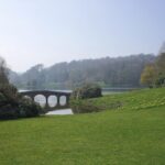 Stourhead in Wiltshire - the garden of a National Trust property showing a lawn leading down to a lake