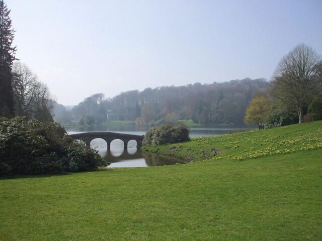 Stourhead in Wiltshire - the garden of a National Trust property showing a lawn leading down to a lake