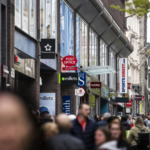 a crowd of people in a shopping area
