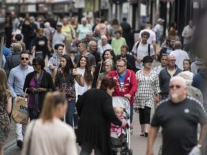 a crowd of people in a shopping area