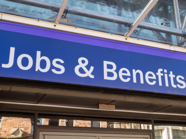 Jobs and Benefits sign displayed prominently on a building exterior. Clear blue background with white text.