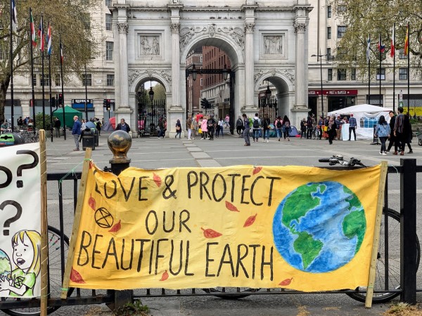environment protest in front of Marble Arch, London. Banner reads: Save and protect our beautiful Earth. Photo by John Cameron on Unsplash